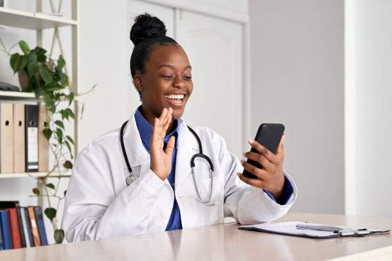 African,Female,Doctor,Holding,Phone,Talk,To,Patient,Make,Telemedicine